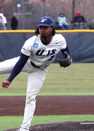 Kyle Tyler pitching in white UIS baseball uniform