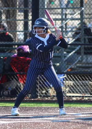Sidney Sawyer playing softball in blue UIS uniform