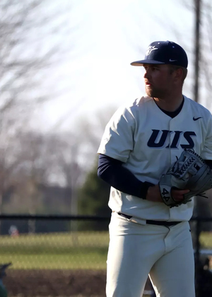 Quinn Hoftender pitching in white UIS uniform