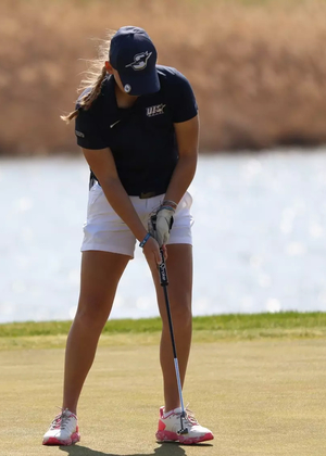 Elaine Grant golfing in blue UIS hat and polo