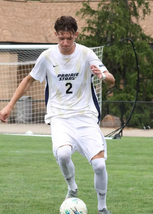 Lennard Borgs playing soccer in white UIS uniform