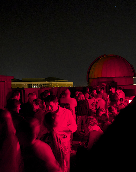 A crowd of people on the roof of Brookens Library for a Star Party.