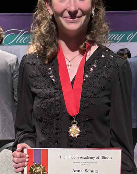 Anna Schurz holding the award