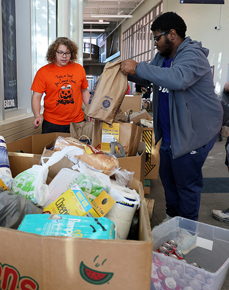 Students put collected food inside bins