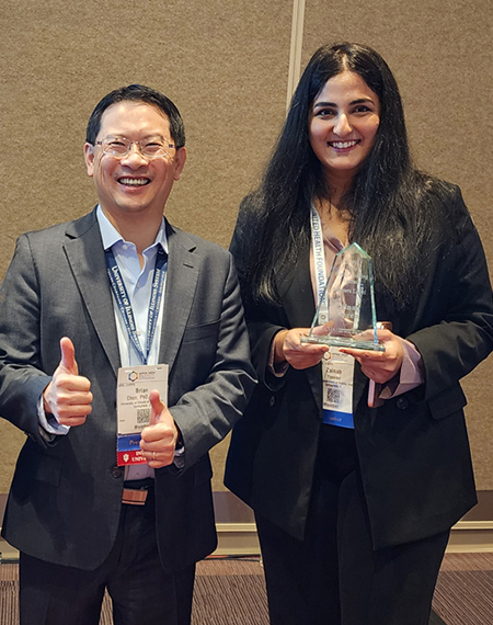 Brian Chen and Zainab Yaseen pose with the award.