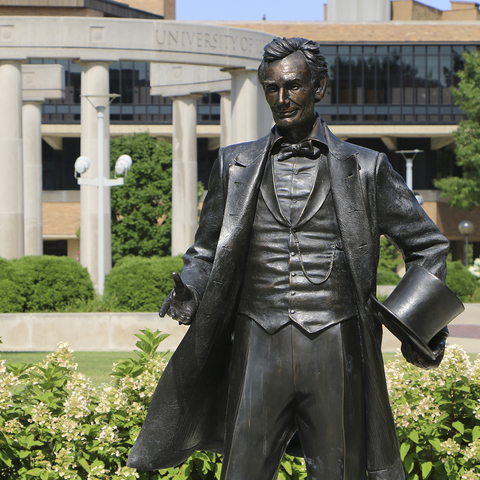 statue of Lincoln with the UIS Colonnade in the background