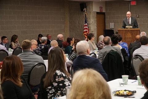 Picture of speaker before an audience at the Center convocation in 2019