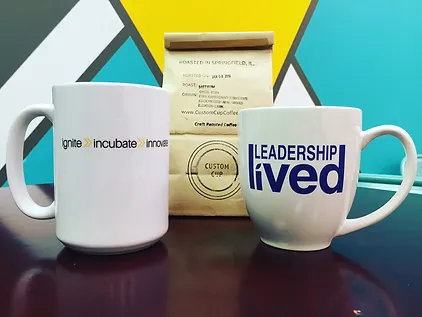 Innovate Springfield and Leadership Lived mugs with coffee grounds from Custom Cup
