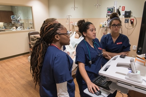 Nurses looking at monitor.