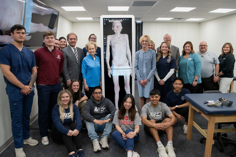 UIS and UIC students along with leaders from UIS and Memorial Health gathered around an Anatomage table displaying a 3D image of a human.
