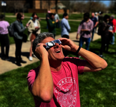 man wearing solar eclipse glasses