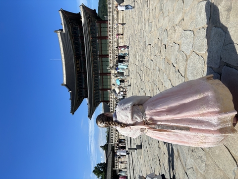 Mackenzie Bateman looking at a historical building in South Korea in traditional dress.