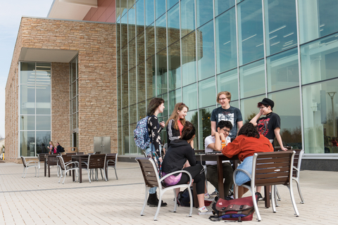students enjoy each others company in front of the Student Union