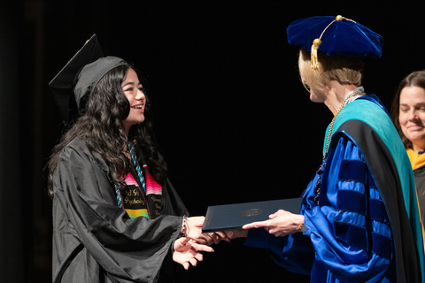female graduate accepting degree from chancellor