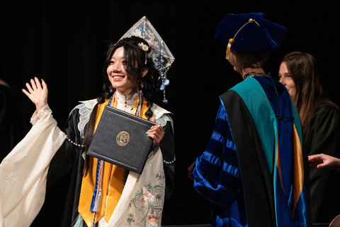 female graduate accepting degree from chancellor