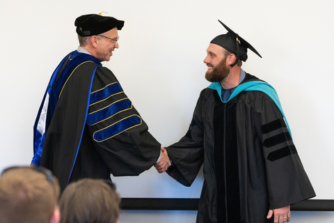 graduate shaking hands with professor
