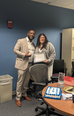 Paty Ortega holding her award next to Dr. Jamarco Clark