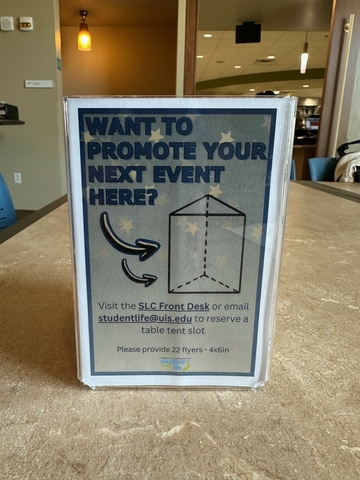 Informational signs displayed on tables in the Student Union for students and visitor guidance and assistance.