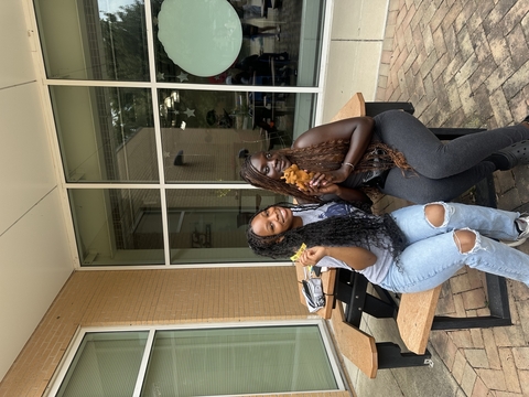 Two students posing for a photo outside.