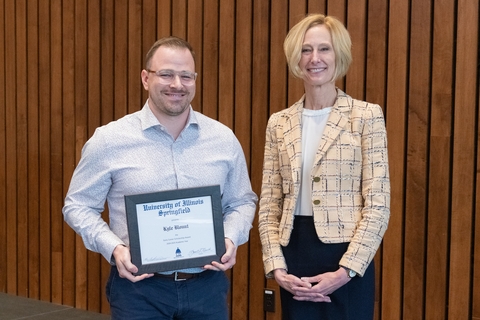 Kyle Blount receiving University of Illinois Springfield award certificate with university administrator