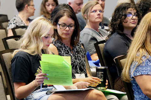 Mother and daughter review paperwork at orientation.