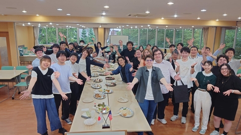 Welcome party posed photo in front of the food