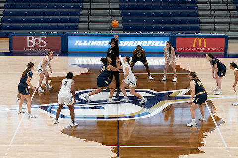 Honest Abe tips off a women's basketball game.