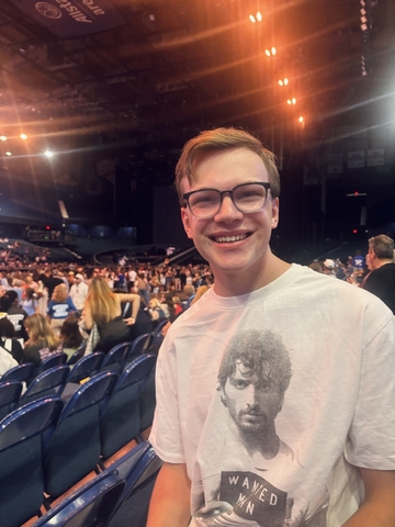 student posed in an auditorium