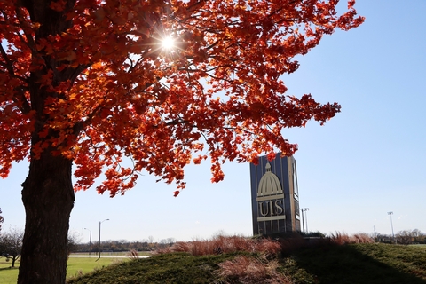 UIS sign next to a tree in autumn