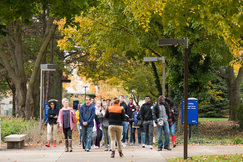 an orientation tour group touring the legacy campus