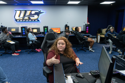 An instructor teaches students in the Esports arena. 