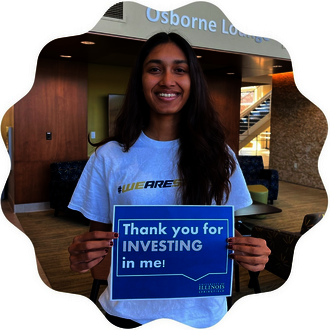 UIS Student holding a sign that says, "Thank you for investing in me!"