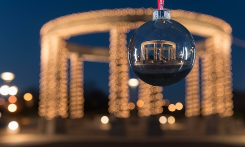 lit up colonnade in the background with ornament of colonnade in foreground