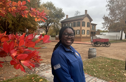 Center for Lincoln Studies intern Alice Abegunde stands in front of the Lincoln Home.