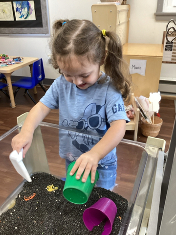 child playing in sensory table