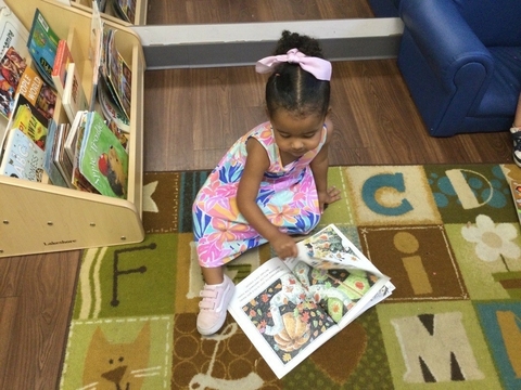 child looking at a book