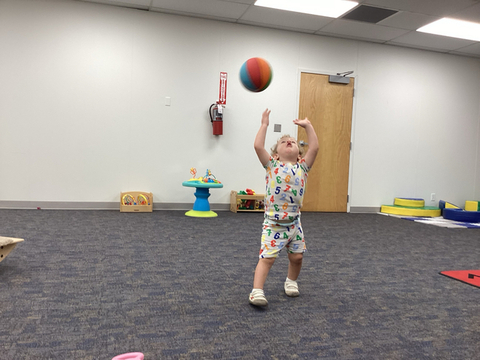 child throwing a ball