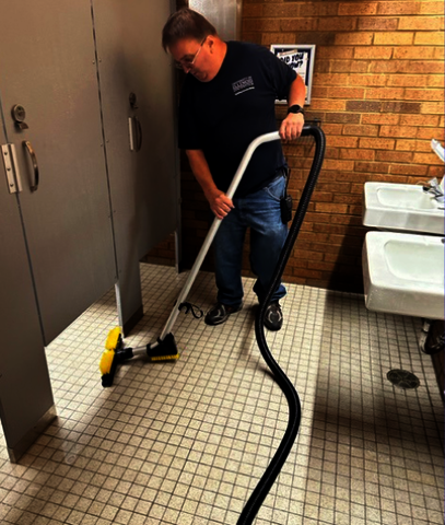 UIS Building Service Workers cleaning bathroom floors