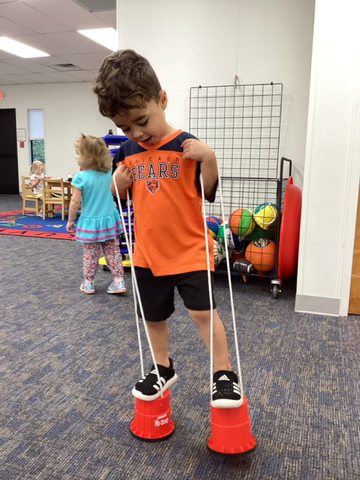 child on can stilts