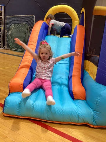 child enjoying a bounce house