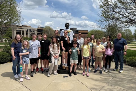 staff and children by Abe Lincoln statue for take your child to work day