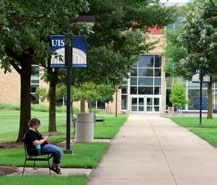 Person sitting on a bench at UIS' campus