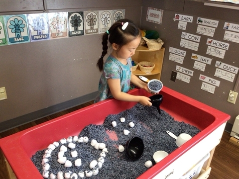 child playing in sensory table