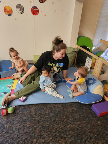 children interacting with their teacher