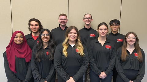 All 9 SOFA members standing and smiling.