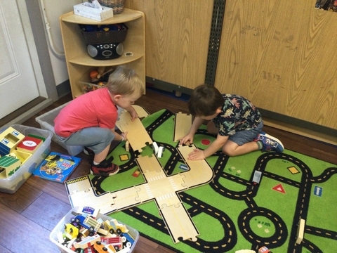 children completing a puzzle