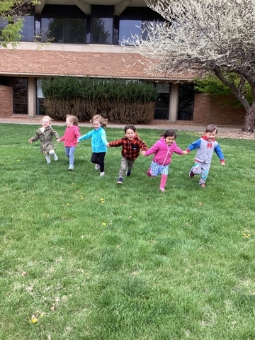 children running outside Brookens Library