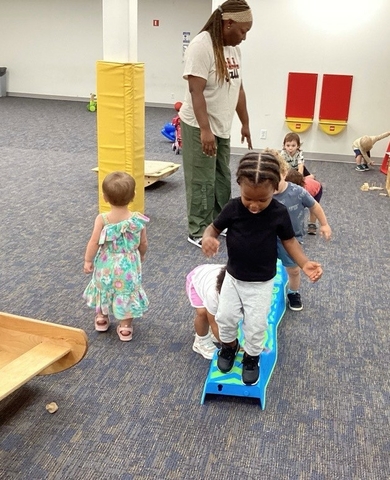 teacher with children in gym