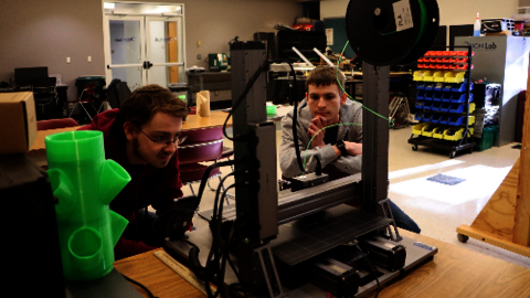 UIS Students operating a 3-D printer in the Orion Lab