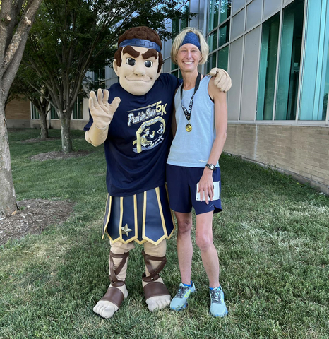 Chancellor Gooch and Orion pose for a picture after the 2023 Prairie Stars 5K